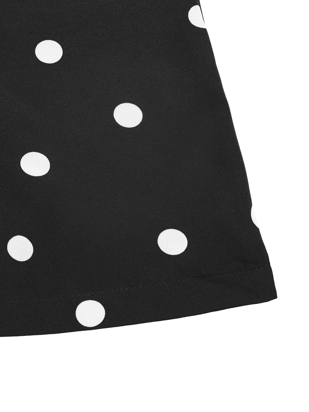Close-up of black fabric with white polka dots from a strapless wide leg jumpsuit.