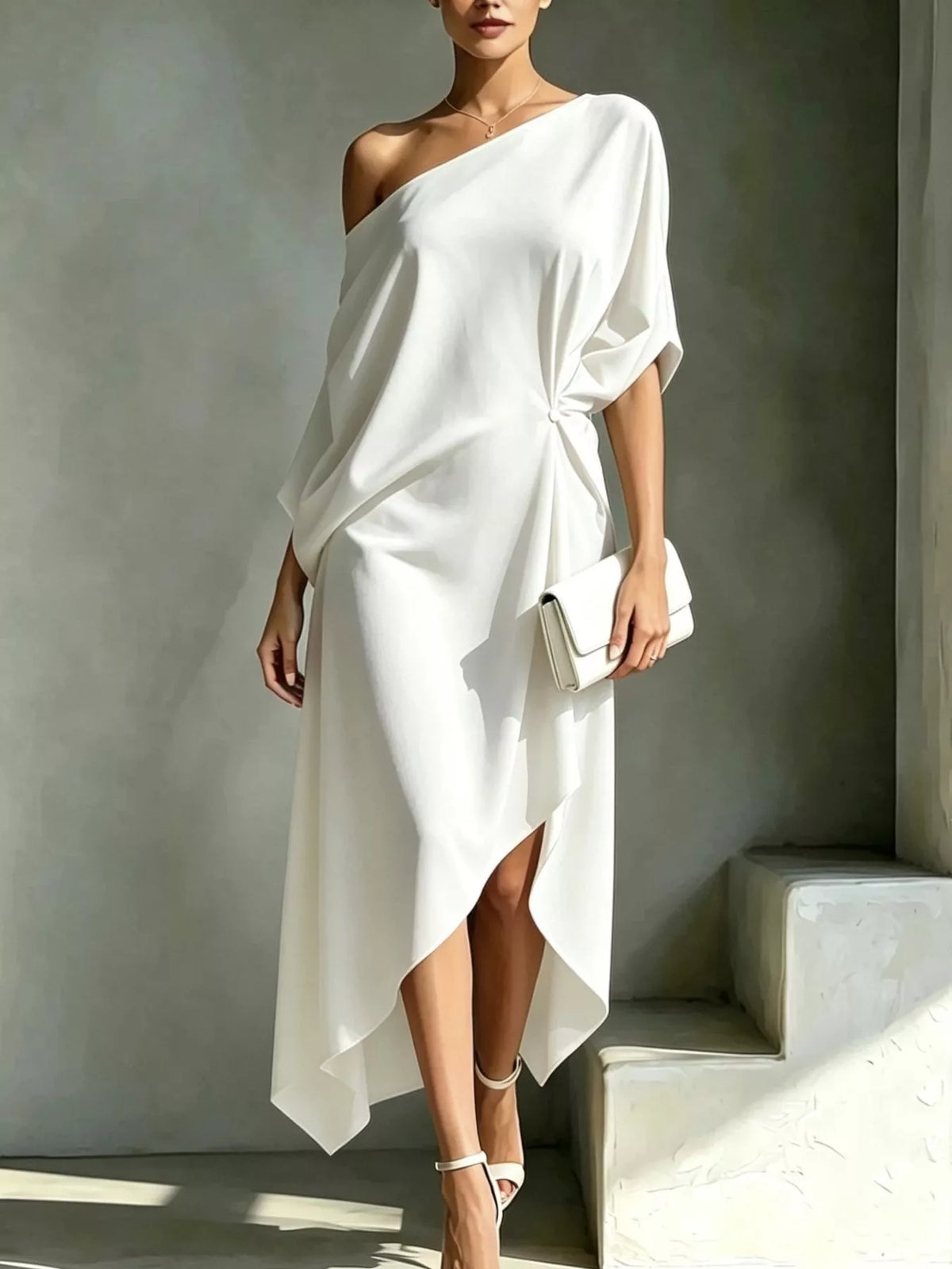 Plus size white asymmetrical one-shoulder drape dress with a knotted detail on the side.