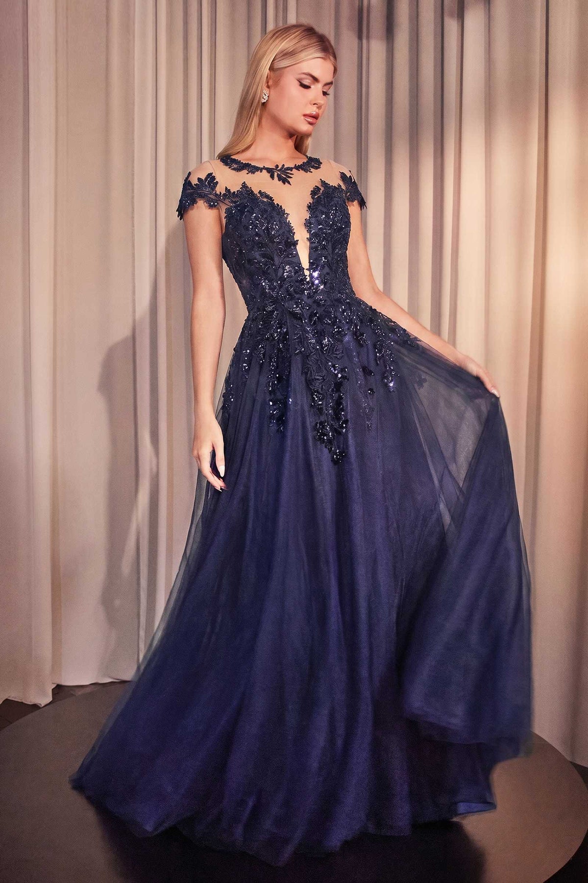 Navy blue A-line gown with cap sleeves, floral appliqué, and sequin embellishments.