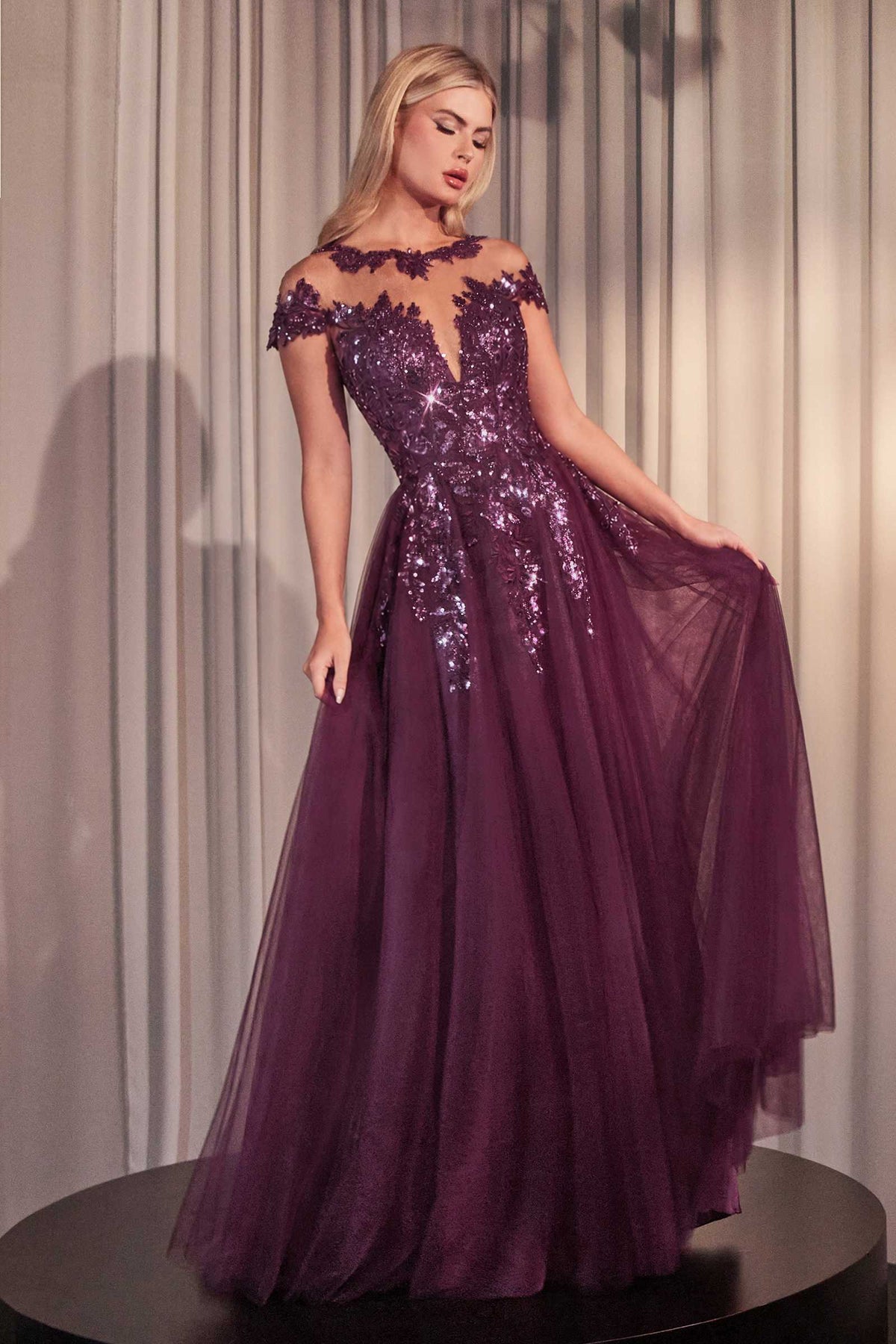 Purple A-line gown with cap sleeves, floral appliqué, and sequin embellishments.