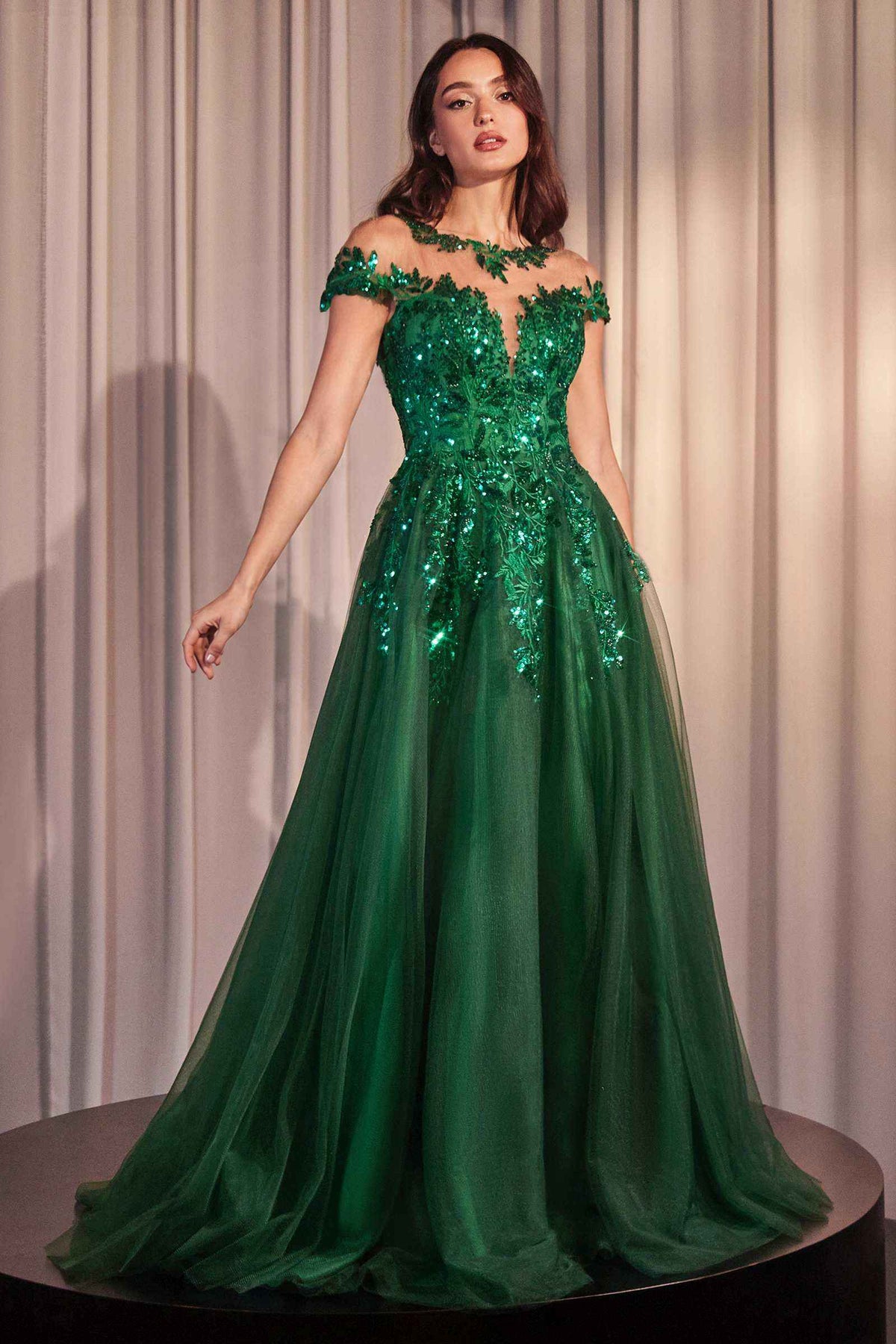 Emerald green A-line gown with cap sleeves, floral appliqué, and sequin embellishments.