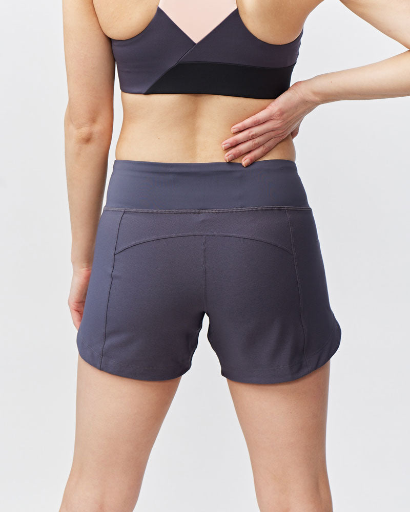 Back view of women's charcoal gray Goal Five Excel workout shorts with a hidden pocket.