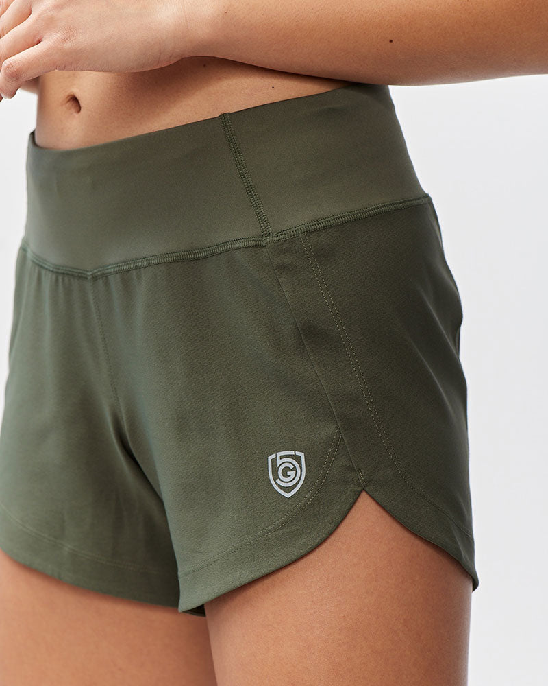 Goal Five Excel Women's Workout Shorts in dark moss green with a silver logo on the side.