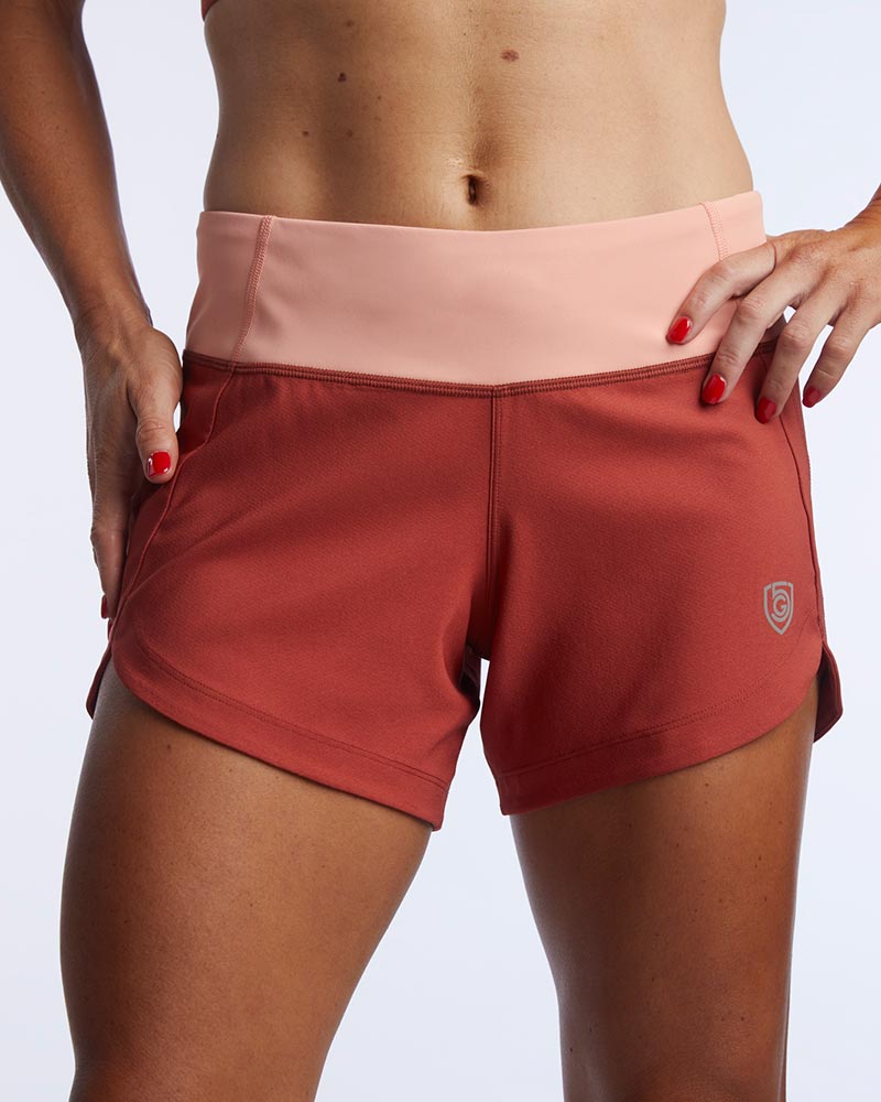 Goal Five Excel Women's Workout Shorts in cinnabar with a faded rose waistband.
