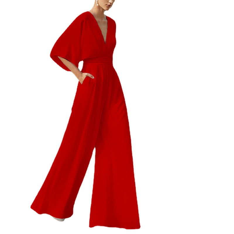 Red wide-leg jumpsuit with a deep V-neck and short kimono sleeves.