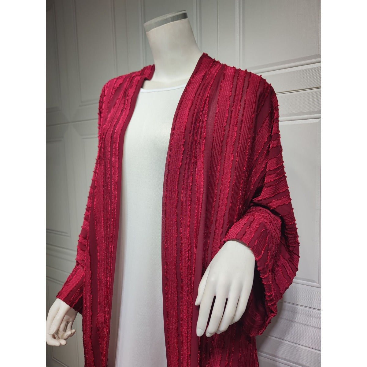Red vintage knitted longline open front cardigan abaya with vertical stripes and fringe details.