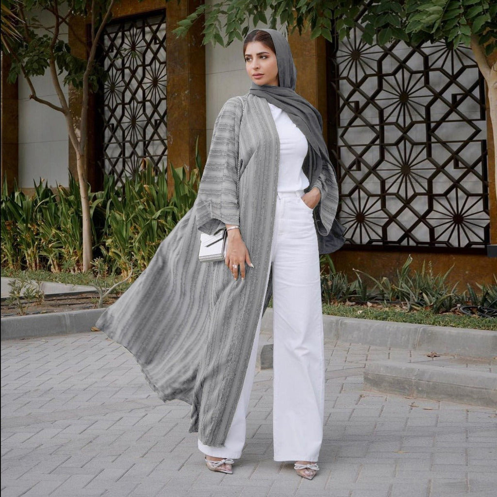 Woman wearing a grey vintage knitted longline open front abaya with textured vertical stripes.